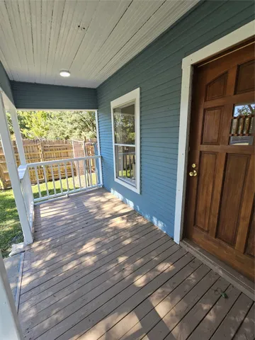 a living room with furniture a window and a chandelier