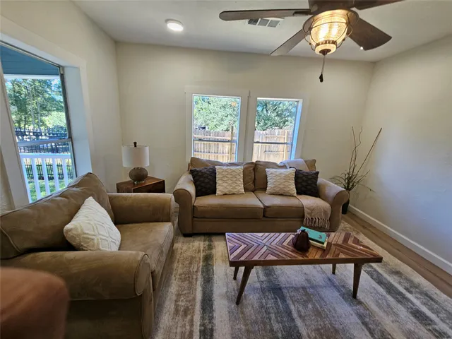 a living room with furniture and a chandelier