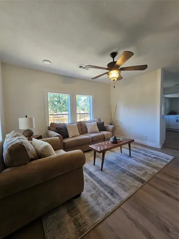 a living room with furniture and white walls