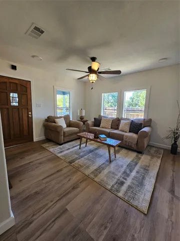 a bathroom with a sink a toilet a mirror and shower