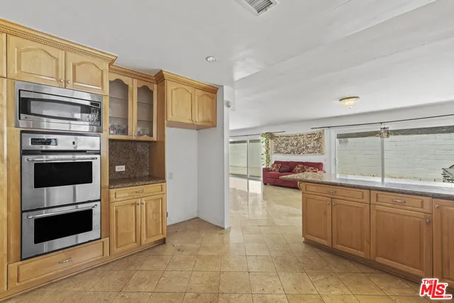 a kitchen with stainless steel appliances a stove sink and cabinets