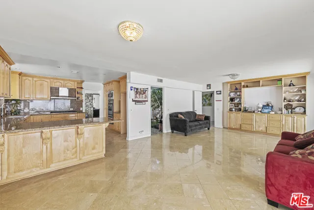 a large white kitchen with cabinets