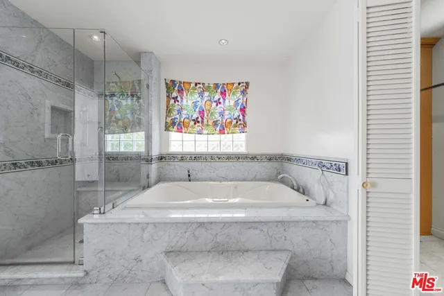 a spacious bathroom with a granite countertop tub sink and mirror