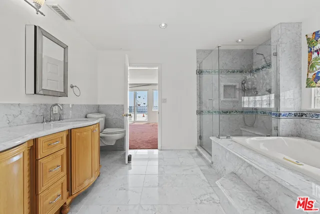 a spacious bathroom with a granite countertop tub sink and mirror
