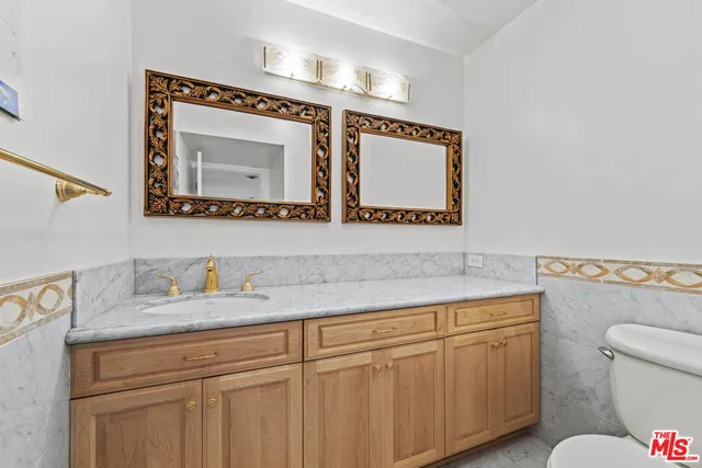 a kitchen with granite countertop white cabinets and sink