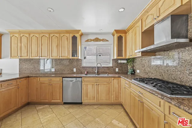 a kitchen with stainless steel appliances granite countertop a sink and cabinets