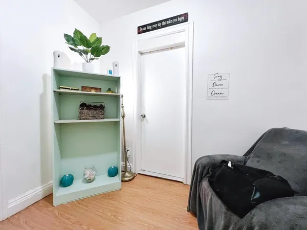 a bedroom with a bed and a potted plant