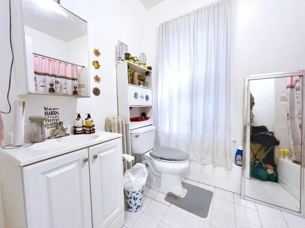 a spacious bathroom with a sink toilet and shower
