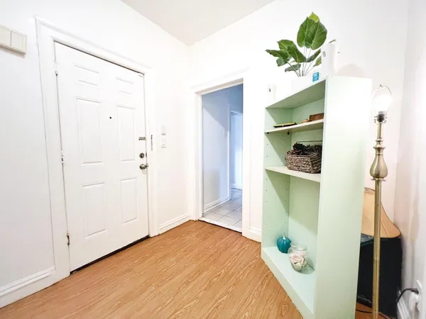 a bedroom with a bed and a potted plant