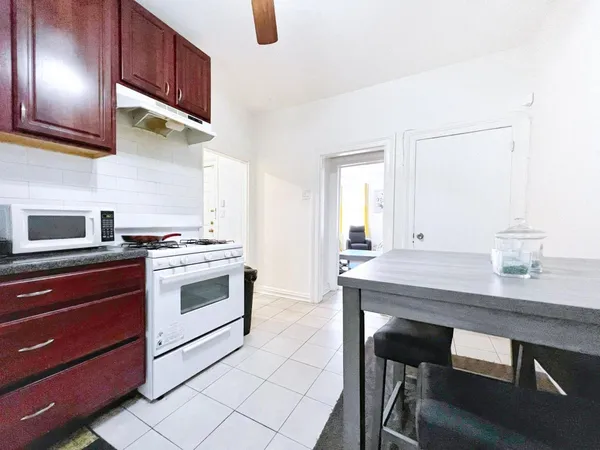 a kitchen with a stove and a chair