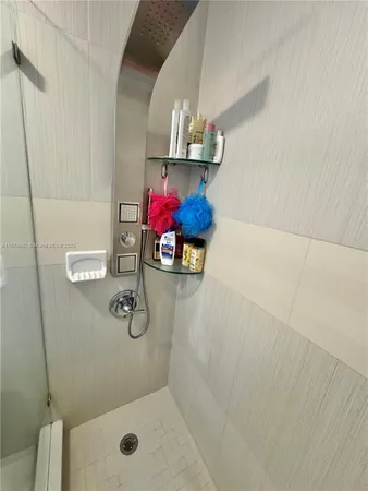 a bathroom with a sink a mirror and a shower