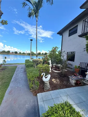 a view of a lake with houses in the back