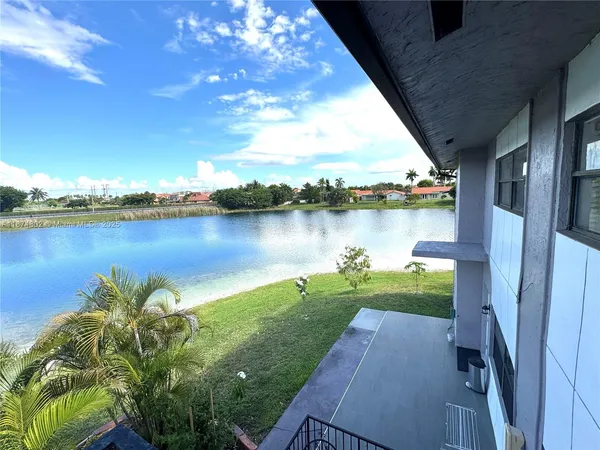 a view of a lake with houses in the back