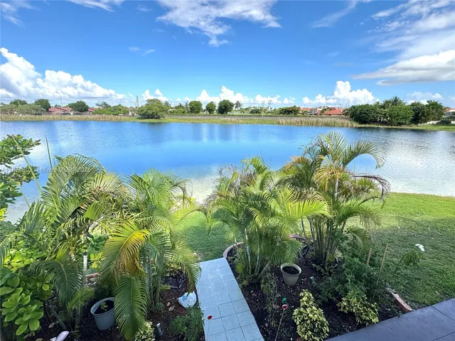a view of a lake with houses in the back