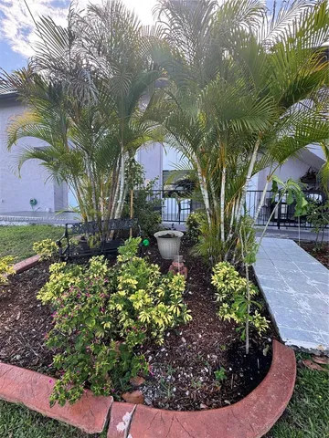 a view of a house with a yard and a fountain