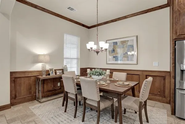 a view of a dining room with furniture and chandelier