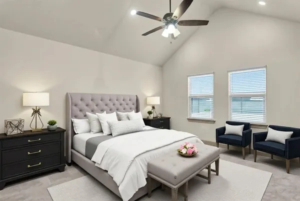 a spacious bedroom with a bed a couch and a window