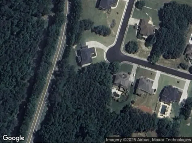 an aerial view of a residential houses with outdoor space