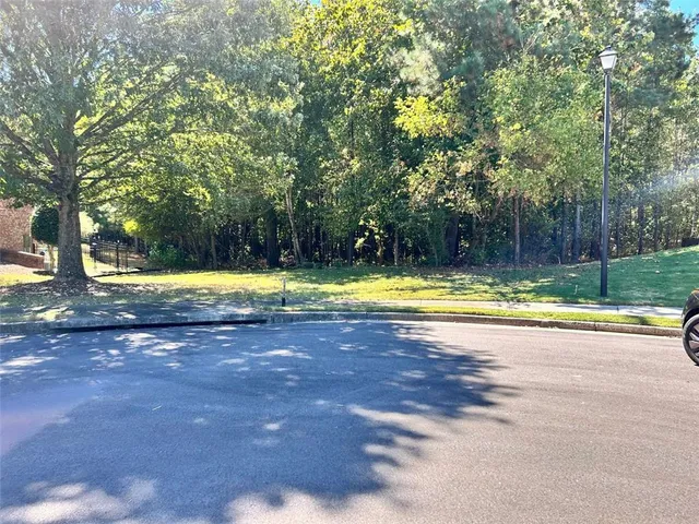 a view of a swimming pool and trees in the background