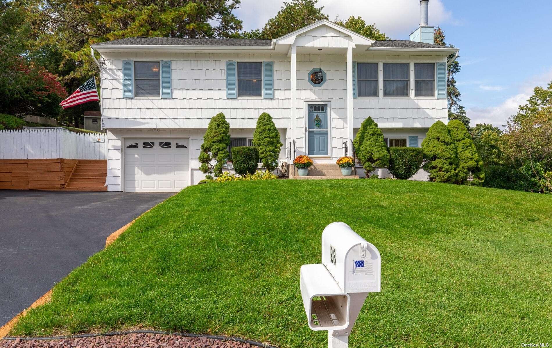 a front view of a house with a garden and plants
