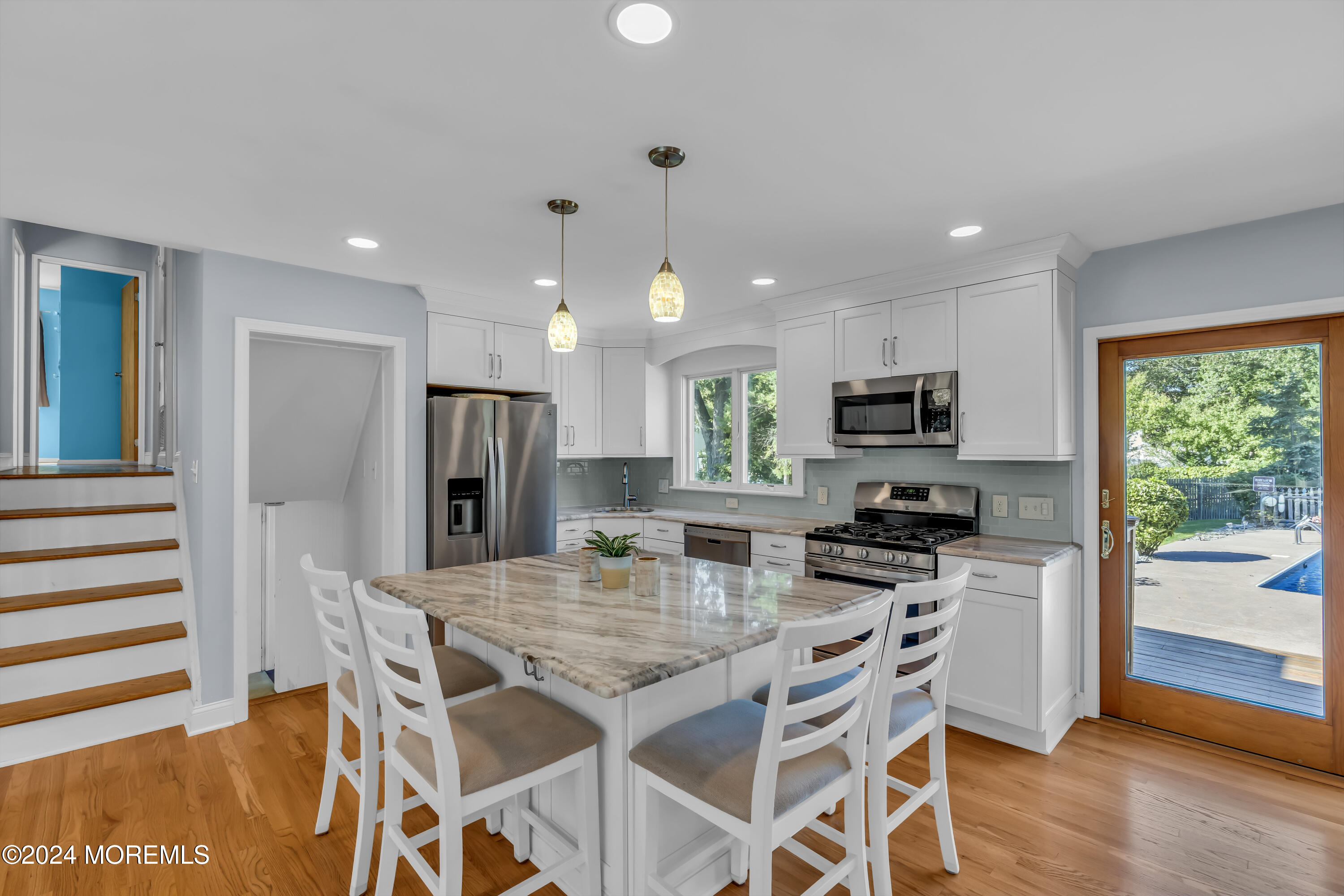 111 Remsen Mill Road Neptune Township, NJ 07753 - Photo 14 of 80 a kitchen with stainless steel appliances kitchen island granite countertop a stove a refrigerator a kitchen island a table and chairs with wooden floor