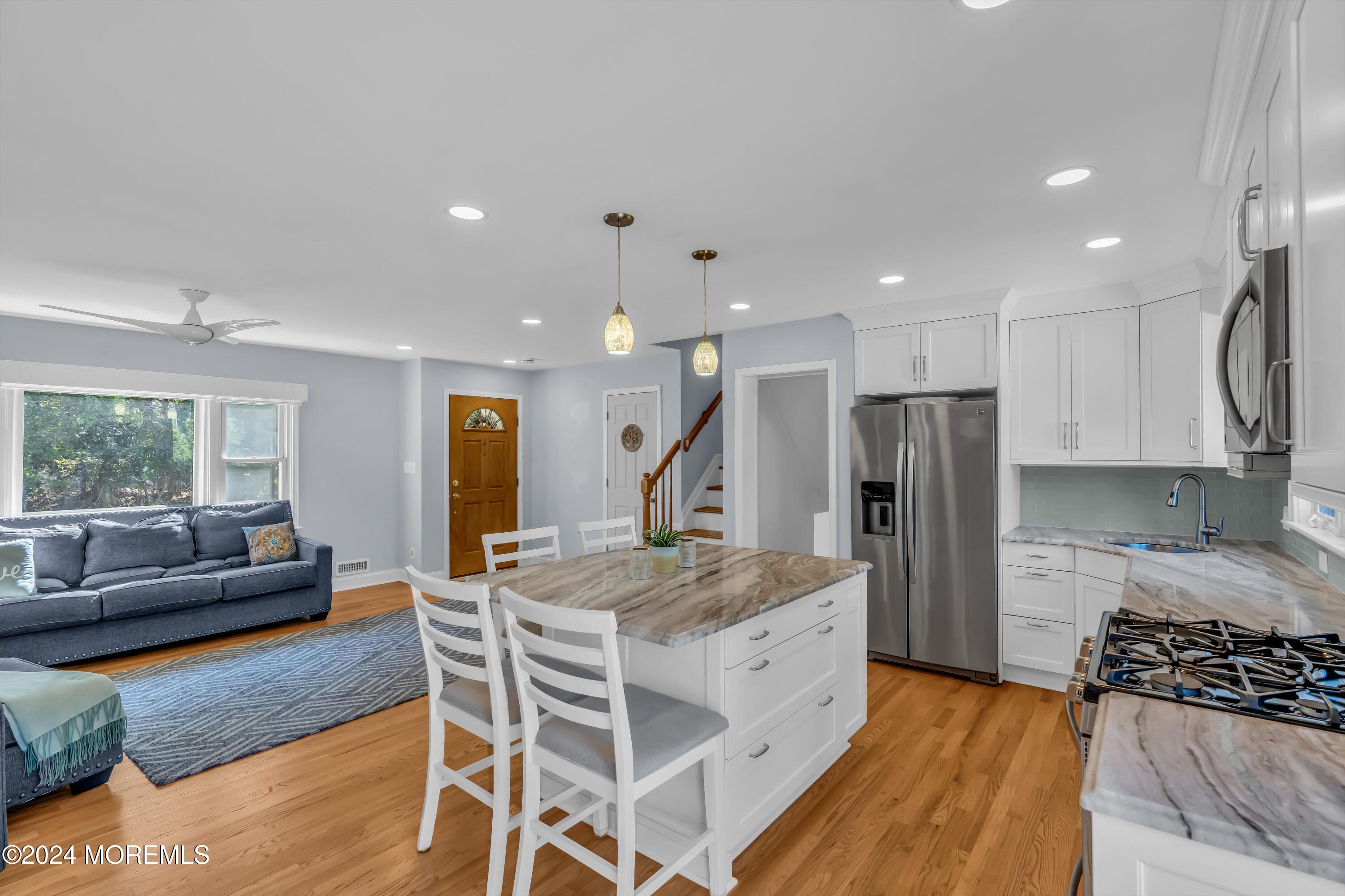 111 Remsen Mill Road Neptune Township, NJ 07753 - Photo 17 of 80 a kitchen with stainless steel appliances kitchen island granite countertop a refrigerator a stove a sink and a dining table with wooden floor