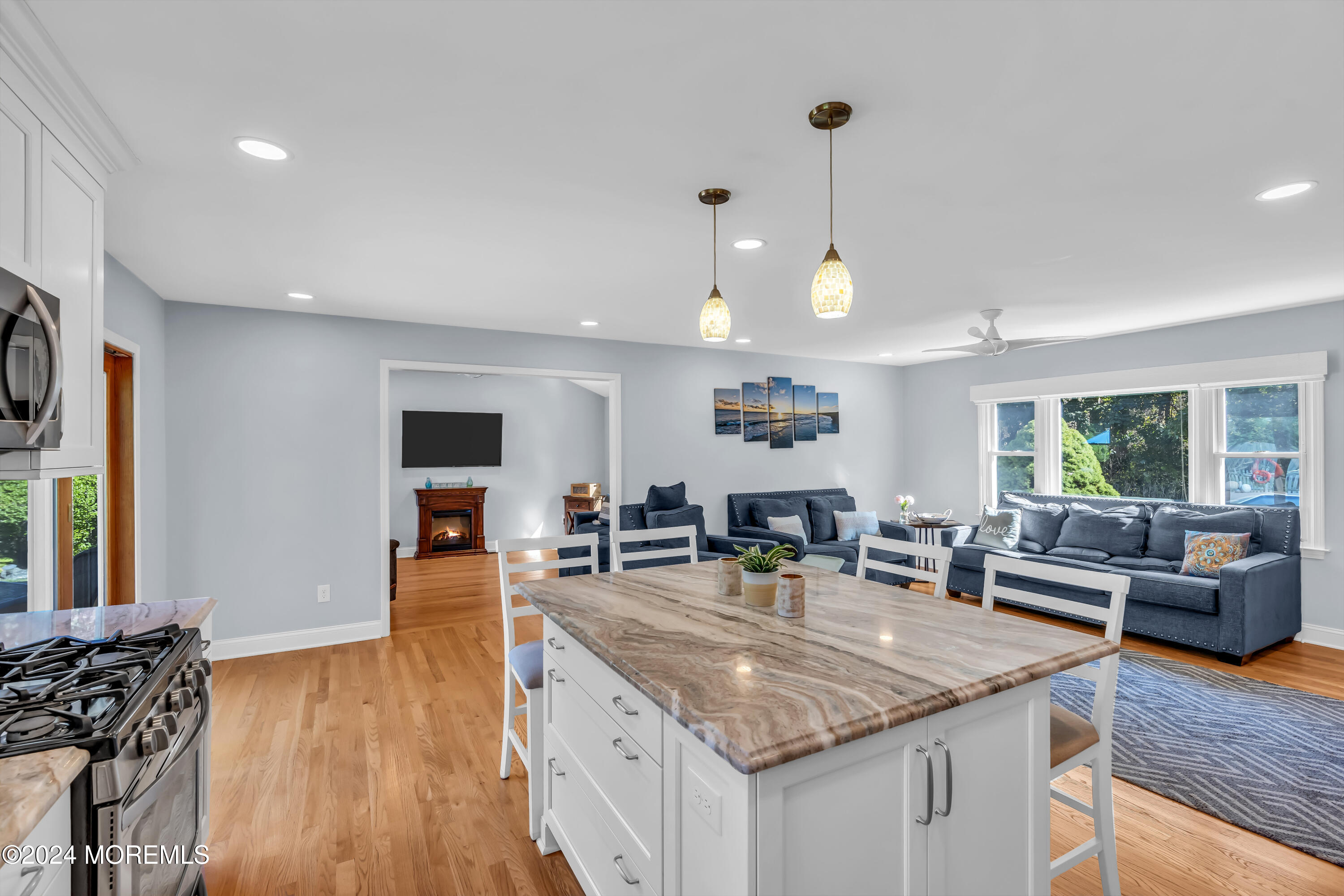 111 Remsen Mill Road Neptune Township, NJ 07753 - Photo 19 of 80 a kitchen with stainless steel appliances granite countertop a sink stove and wooden floor