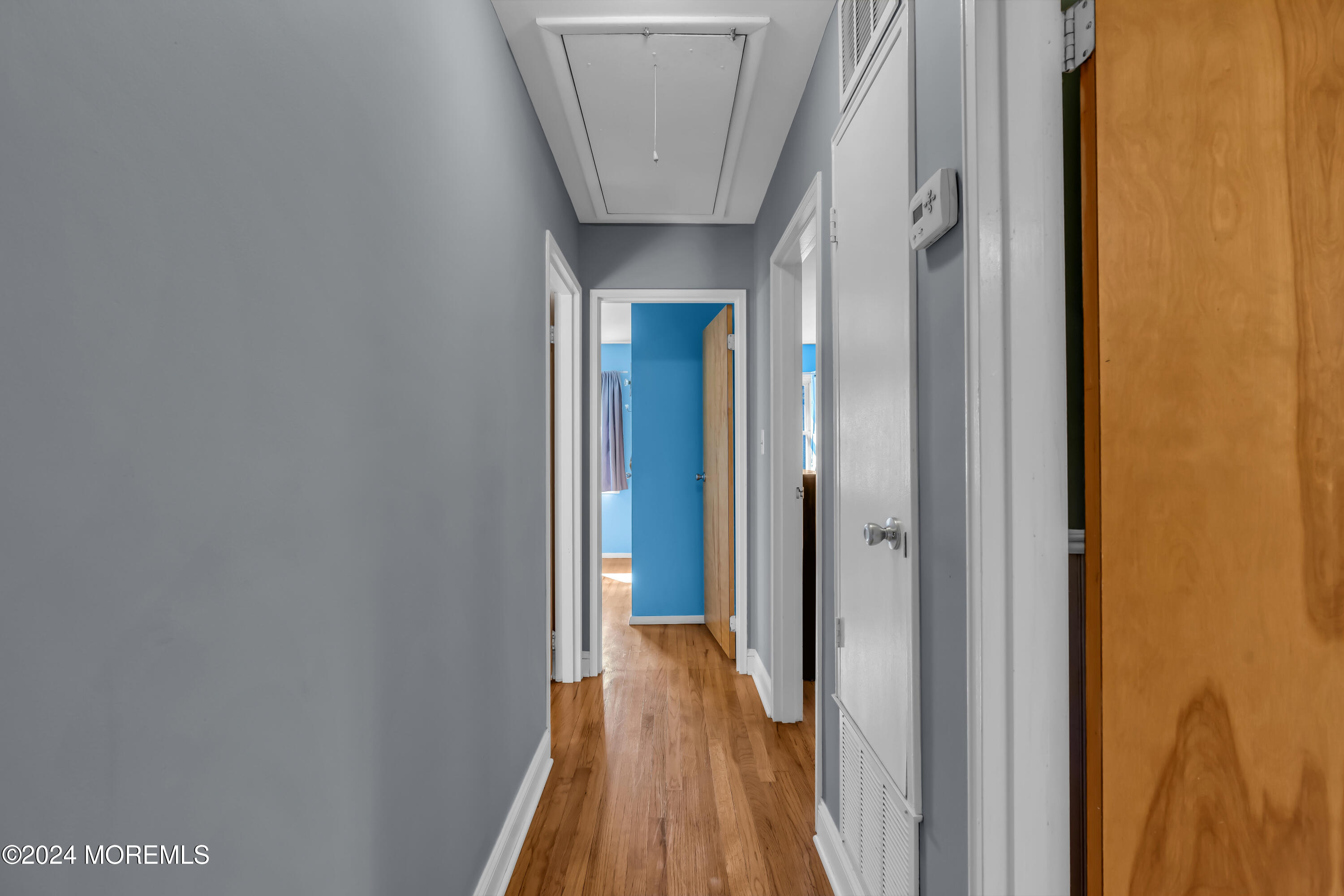 111 Remsen Mill Road Neptune Township, NJ 07753 - Photo 30 of 80 a view of a hallway with wooden floor and a bathroom