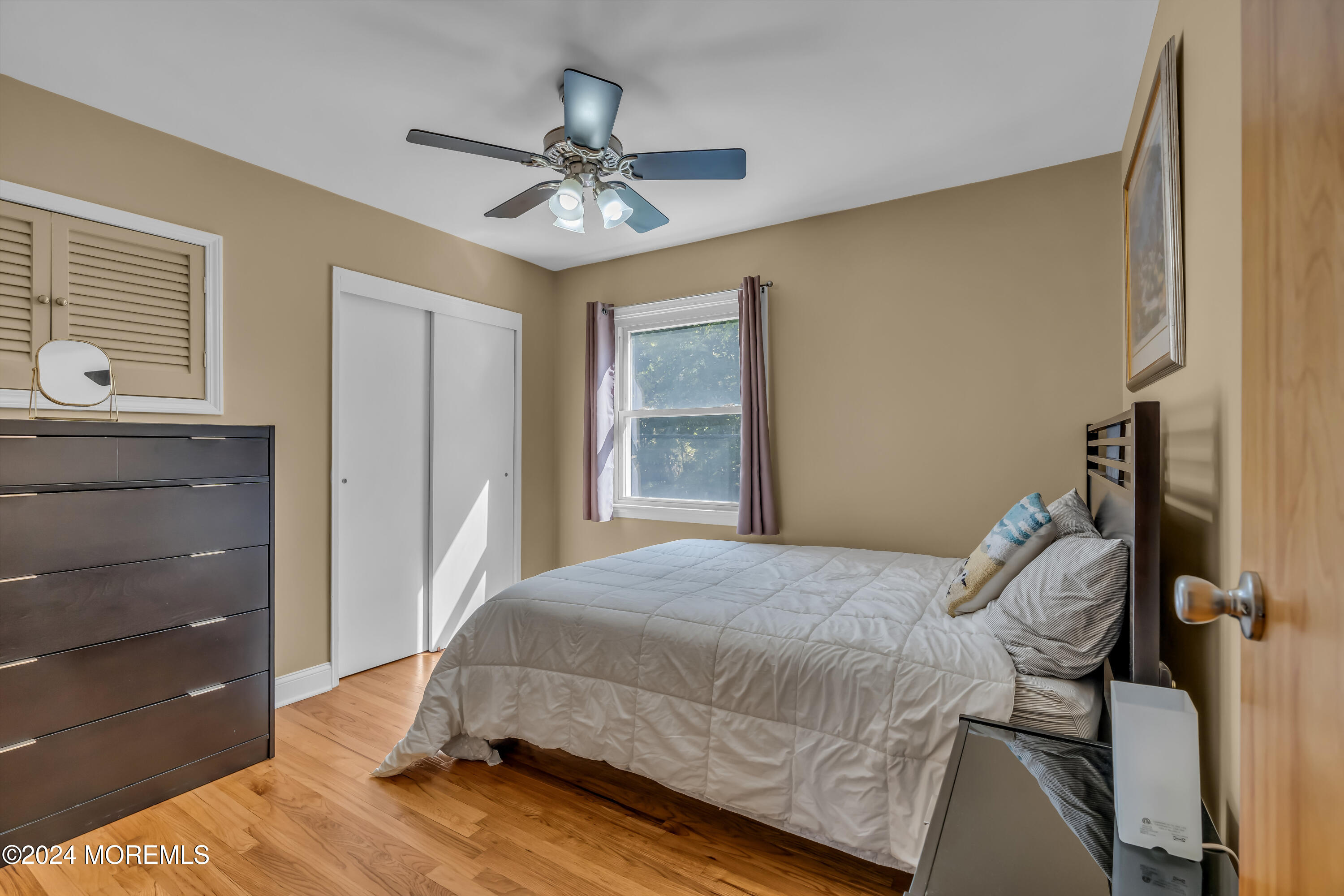 111 Remsen Mill Road Neptune Township, NJ 07753 - Photo 37 of 80 a bedroom with a bed and a chandelier
