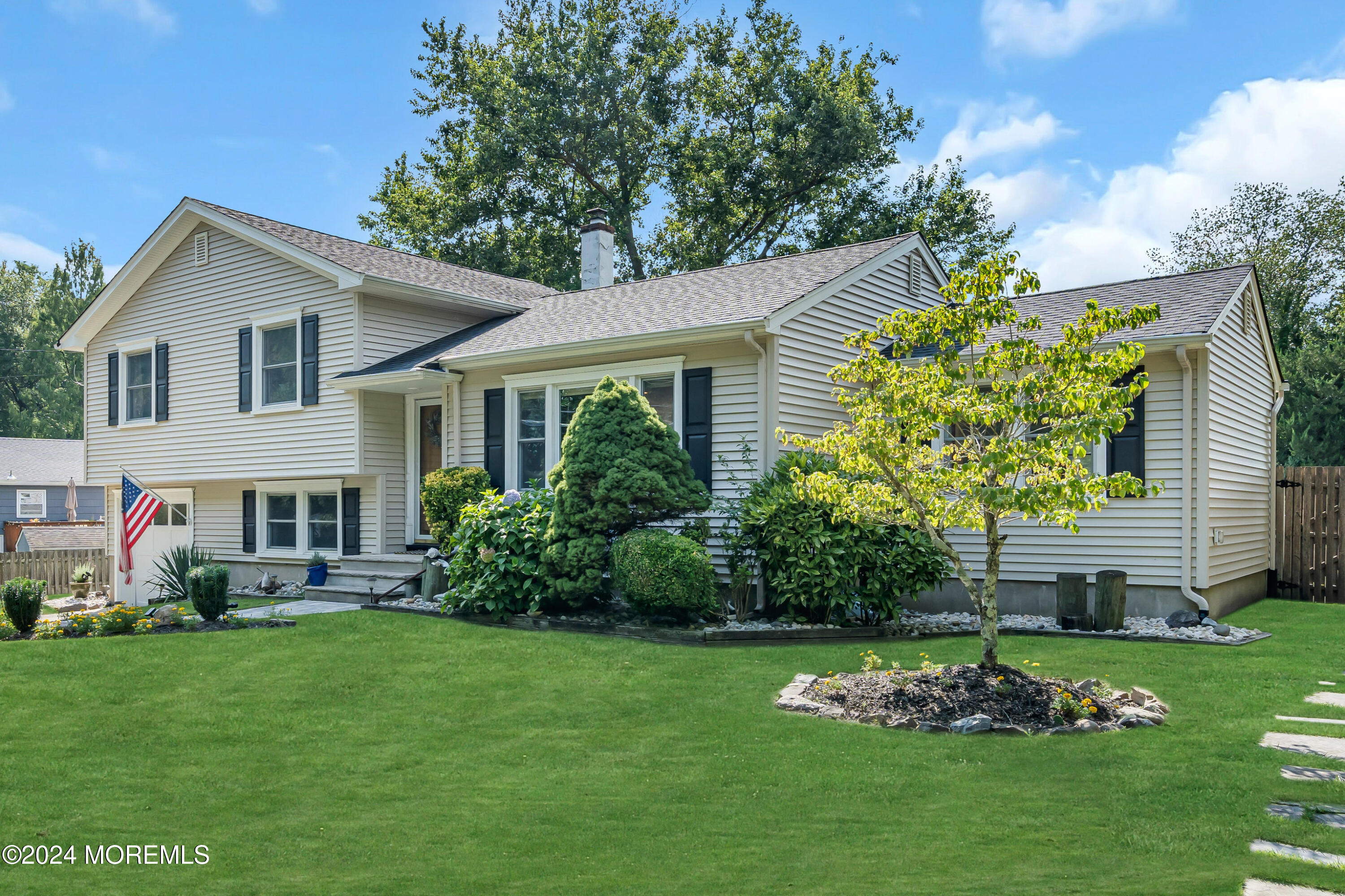 111 Remsen Mill Road Neptune Township, NJ 07753 - Photo 4 of 80 a front view of a house with a garden and plants