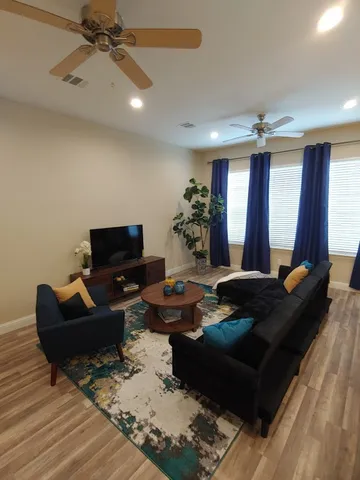 a living room with furniture rug and a large window
