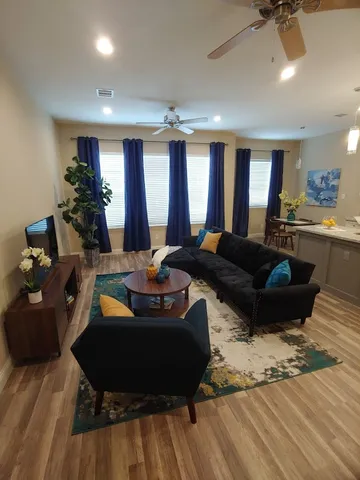 a view of a workspace with furniture and wooden floor