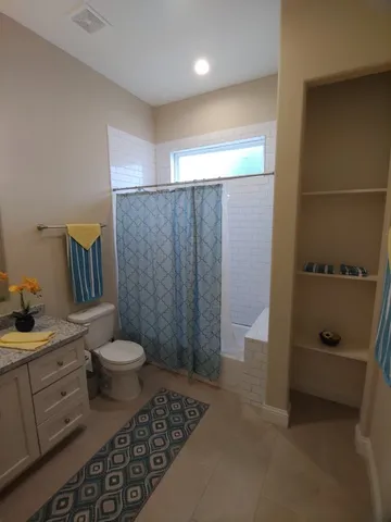 a living room with a couch and dresser