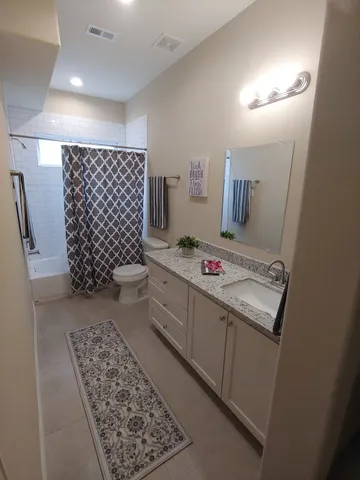 a bedroom with double bed and a chandelier