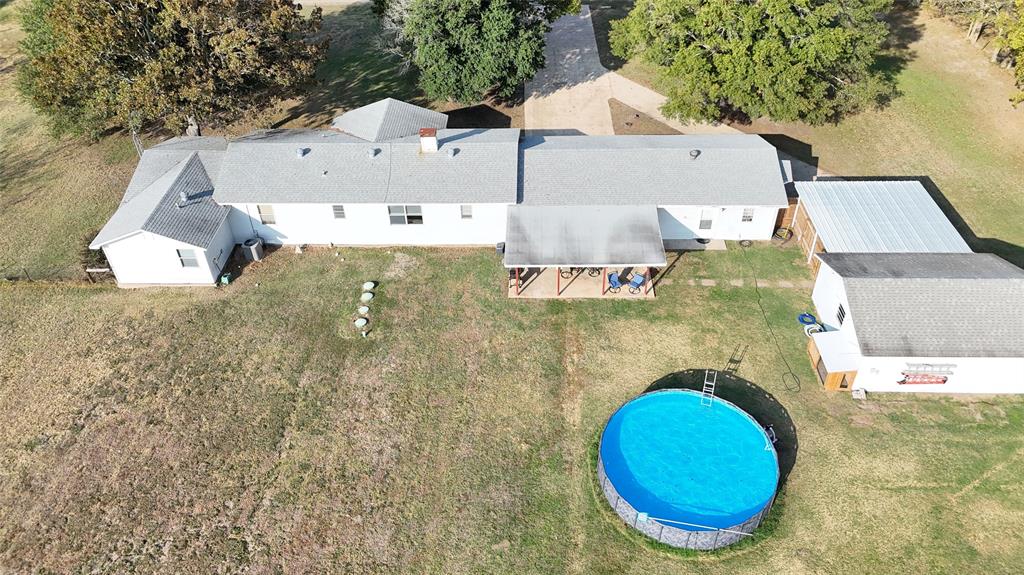 an aerial view of a house with swimming pool
