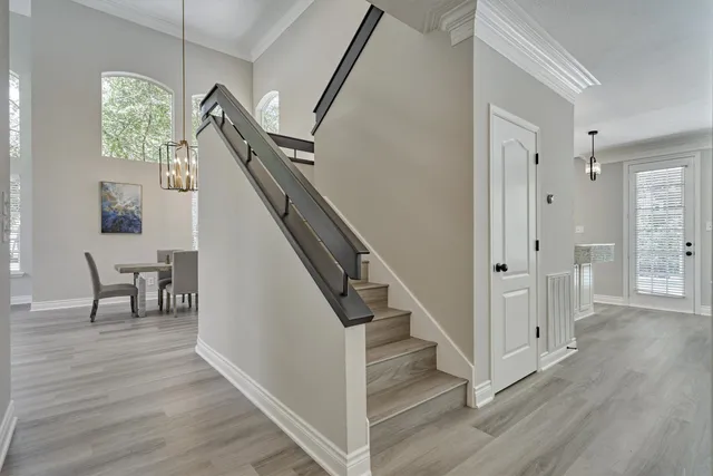 a view of entryway and hall with wooden floor