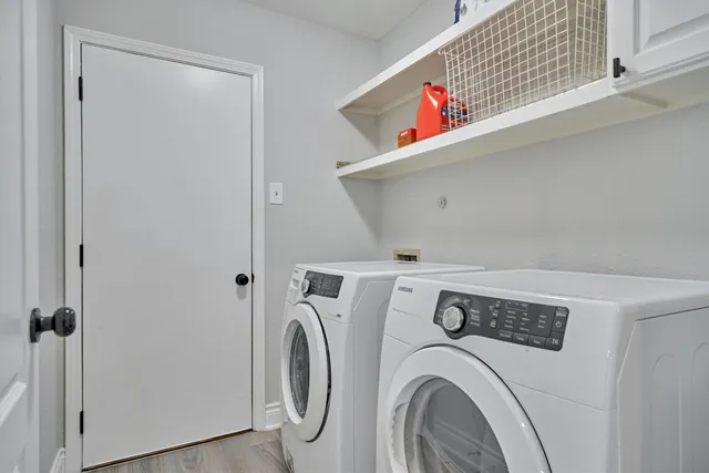 a view of a room with wooden floor and a window