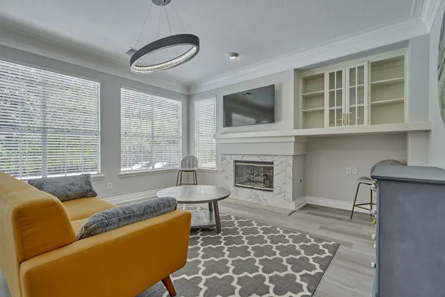 a living room with furniture a rug and a fireplace