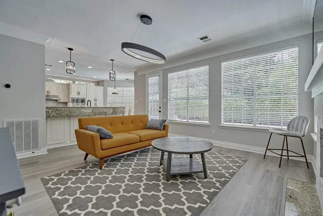 a large kitchen with kitchen island a large counter space and stainless steel appliances