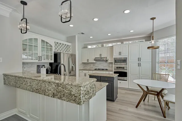 a kitchen with a sink stove and refrigerator