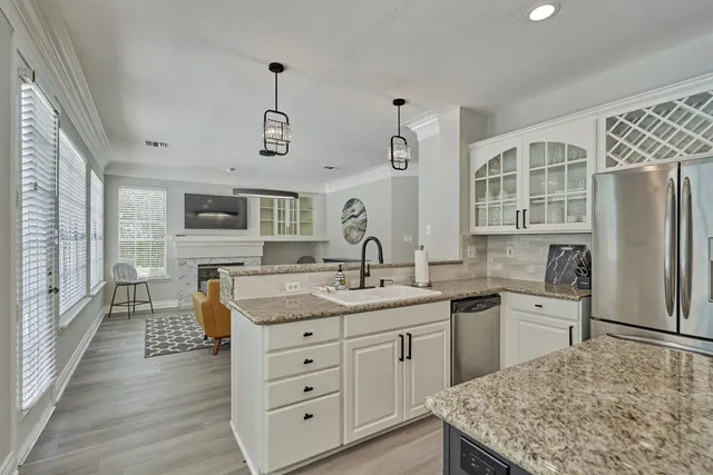 a kitchen with lots of counter top space and wooden floor