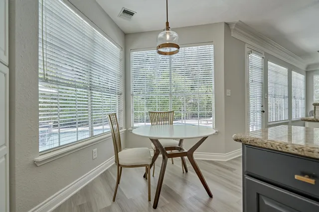 a view of a dining room with furniture and window