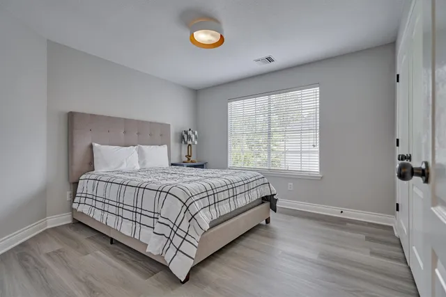 a bedroom with a large bed and a window