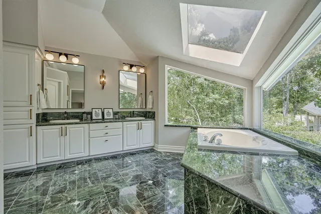 a bathroom with sink mirror and vanity