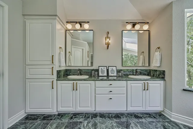 a room with balcony a large window and a bed