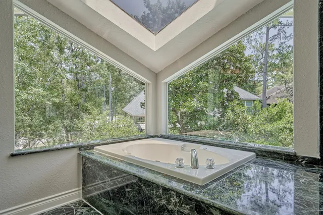 a view of a backyard with swimming pool and furniture