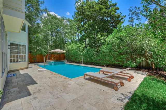 a view of a house with backyard and sitting area