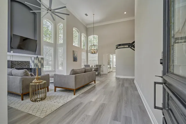 a living room with furniture a flat screen tv and a fireplace