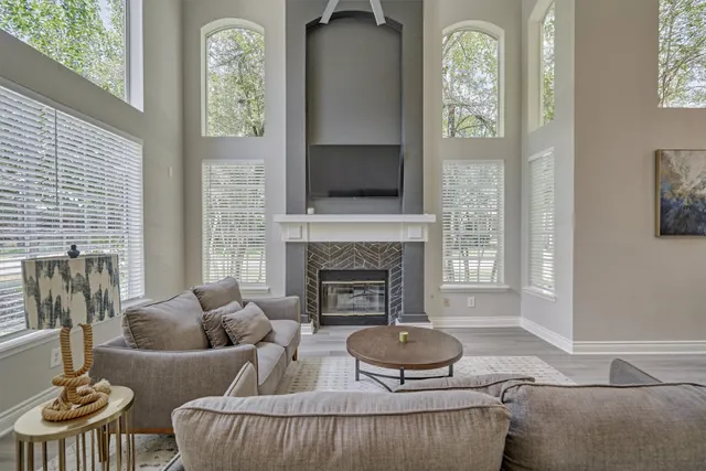 a living room with furniture and a fireplace