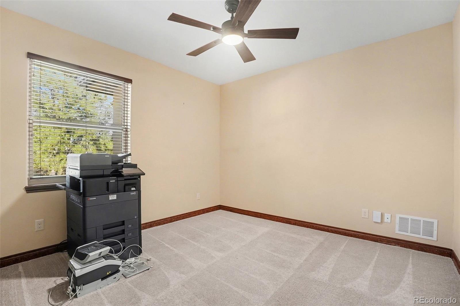 7936 Monarch Road Larkspur, CO 80118 - Photo 14 of 24 a view of a workspace with furniture and a window